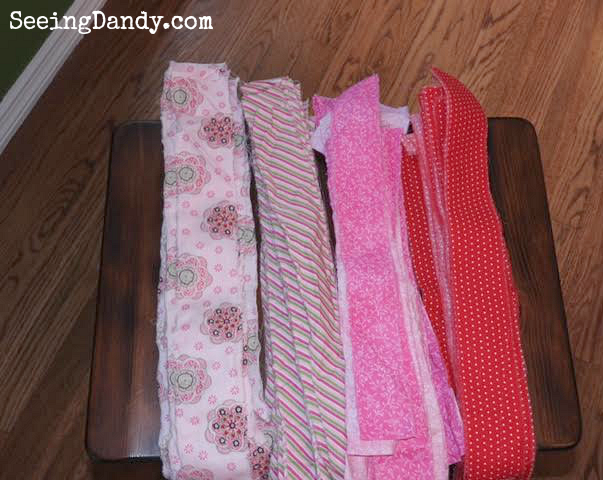 Strips of fabric in pink and red colors for the Valentine rag wreaths.