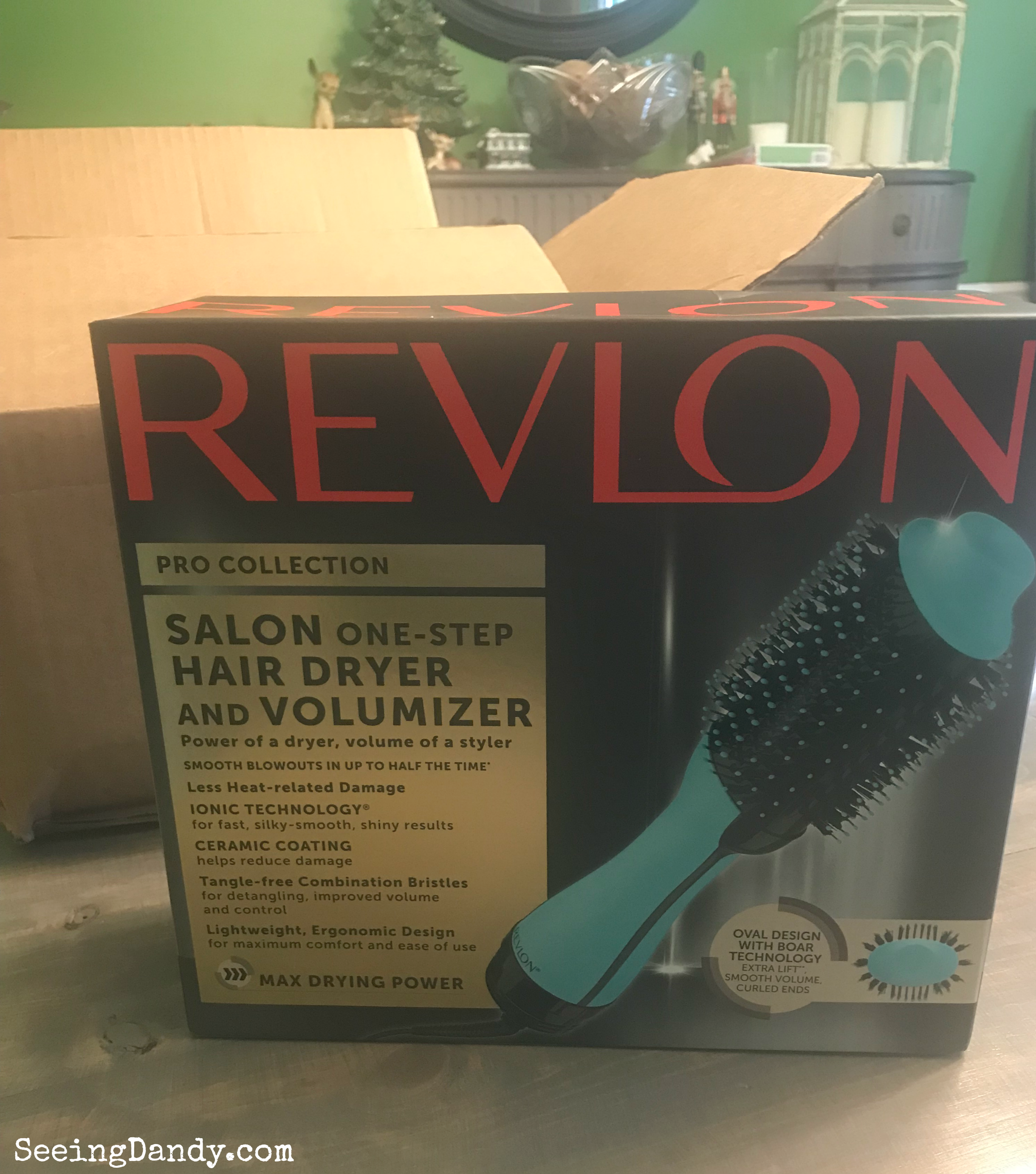 Revlon One Step Hair Dryer and Volumizer unboxing in modern farmhouse dining room. Box on farmhouse table with ceramic Christmas tree and other holiday decorations in the background.