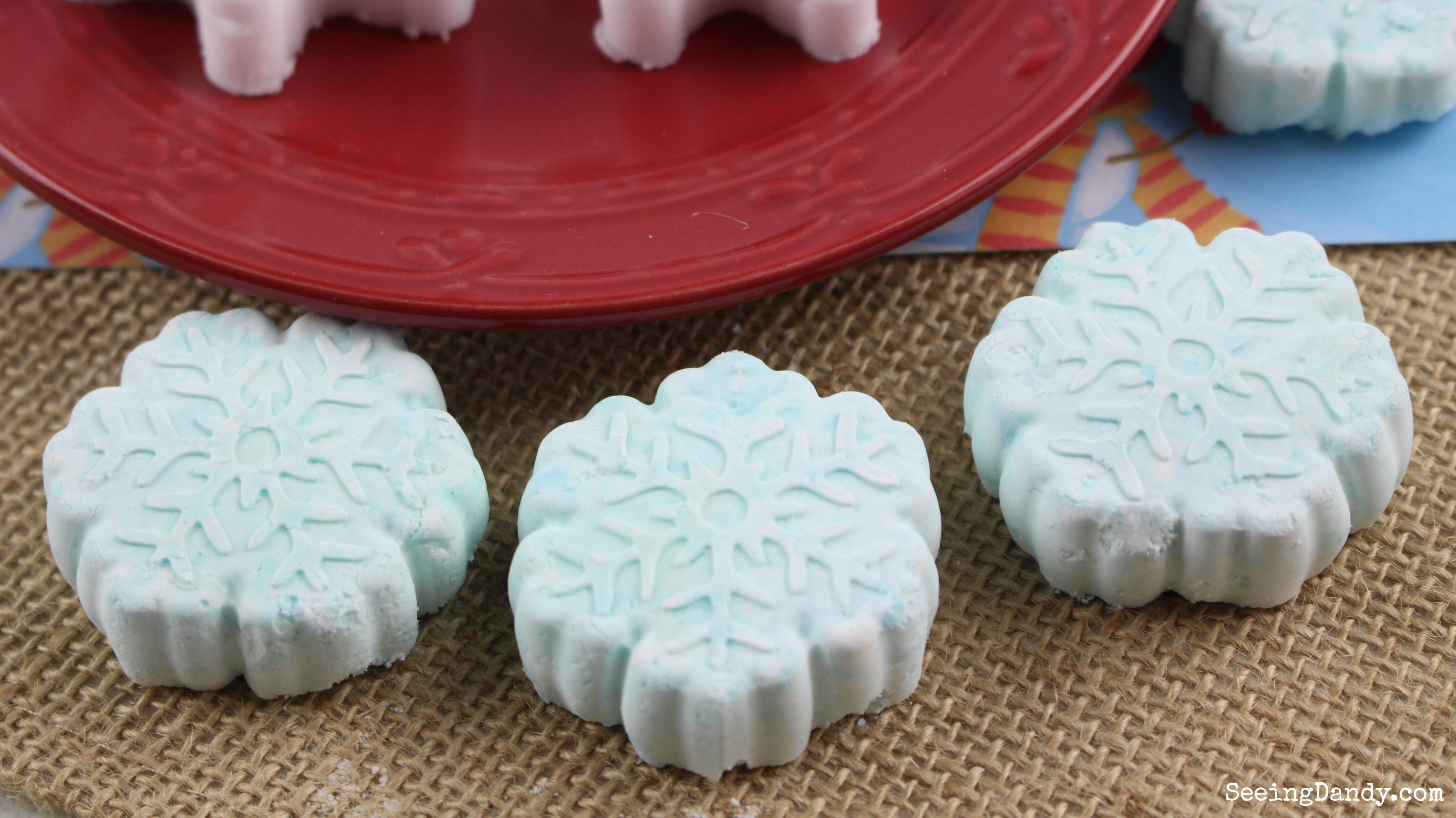 Great gift idea for healthy and beauty. Snowflake peppermint shower steamers on red plate and burlap.