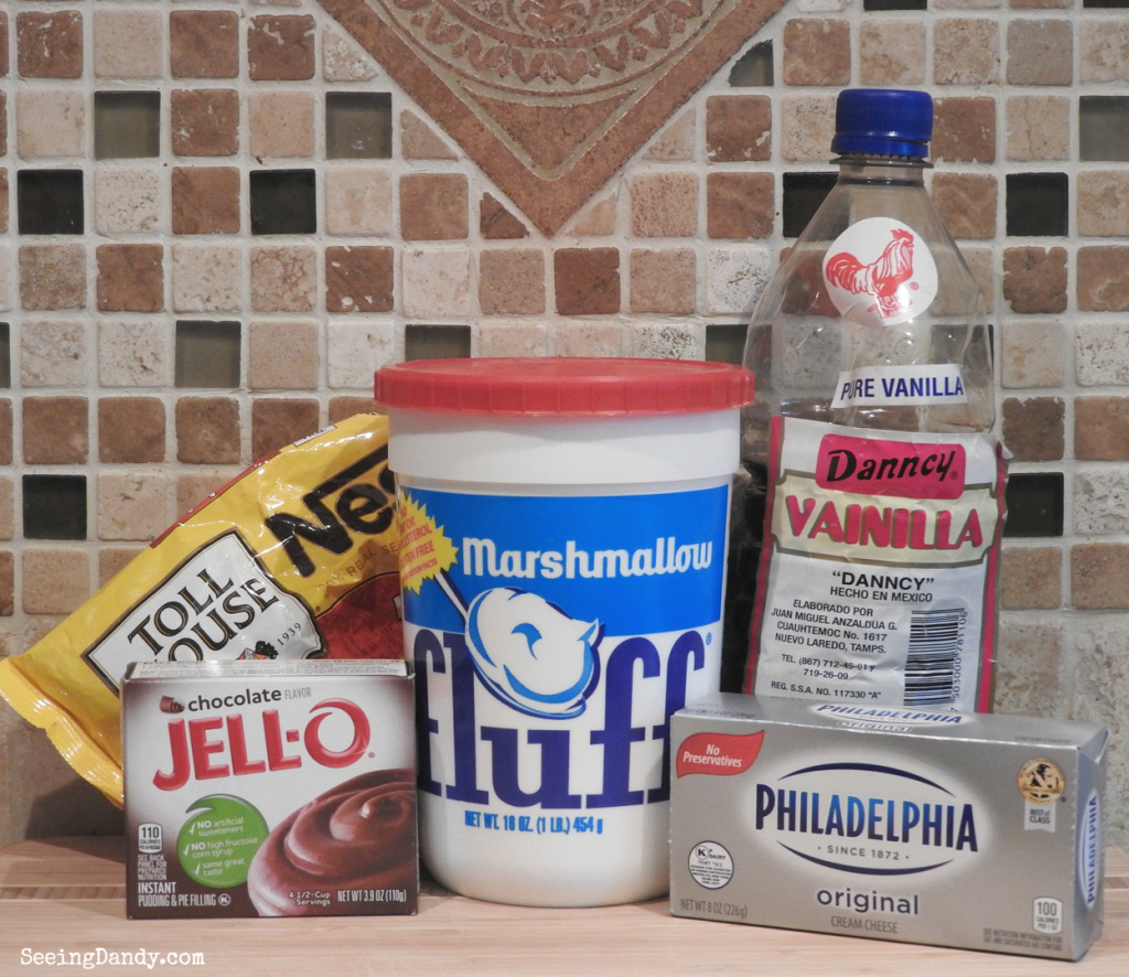 Ingredients for making Fluffy Chocolate Fruit Dip with kitchen backsplash tile. Toll House chocolate chips, cream cheese, chocolate pudding, marshmallow fluff, mexican vanilla.