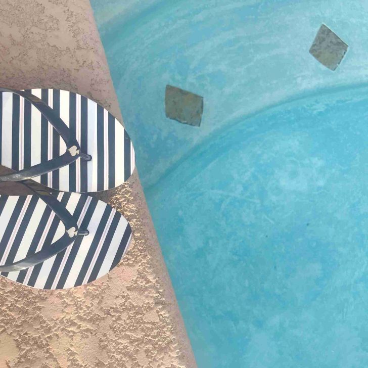 Swimming pool and stripe flip flops in blue and white.