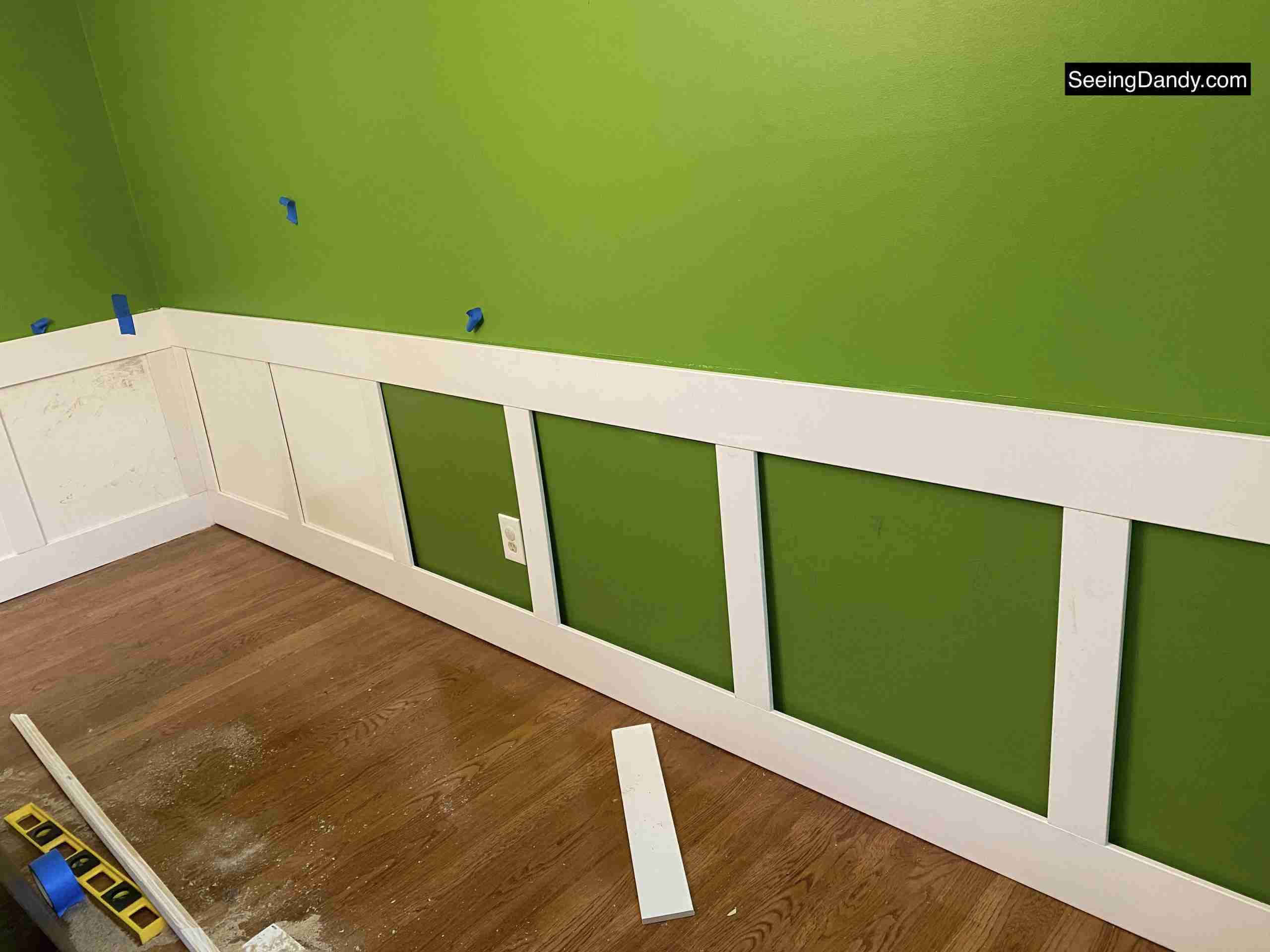 diy wainscoting, dining room wainscoting, kate spade green wall, behr paint, bold avocado green wall, square wainscoting, dining room decor, farmhouse style decorating, dining room hardwood floor 