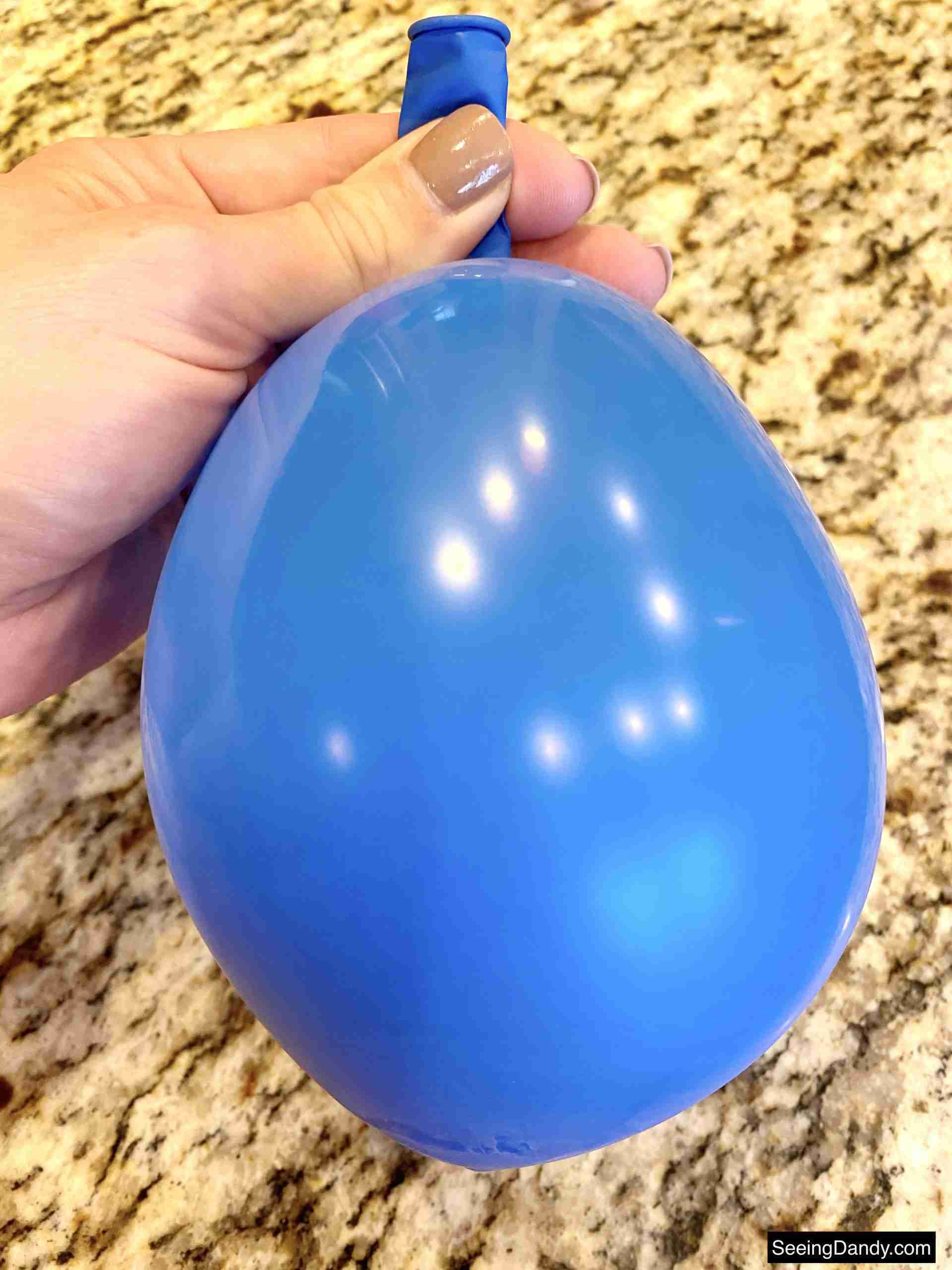 blue balloon, granite countertop, taupe gel nail polish