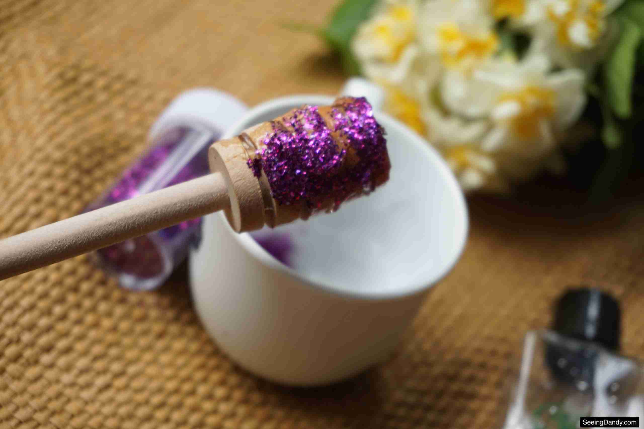 honey dipper stick, jute rug, white tea cup, purple glitter