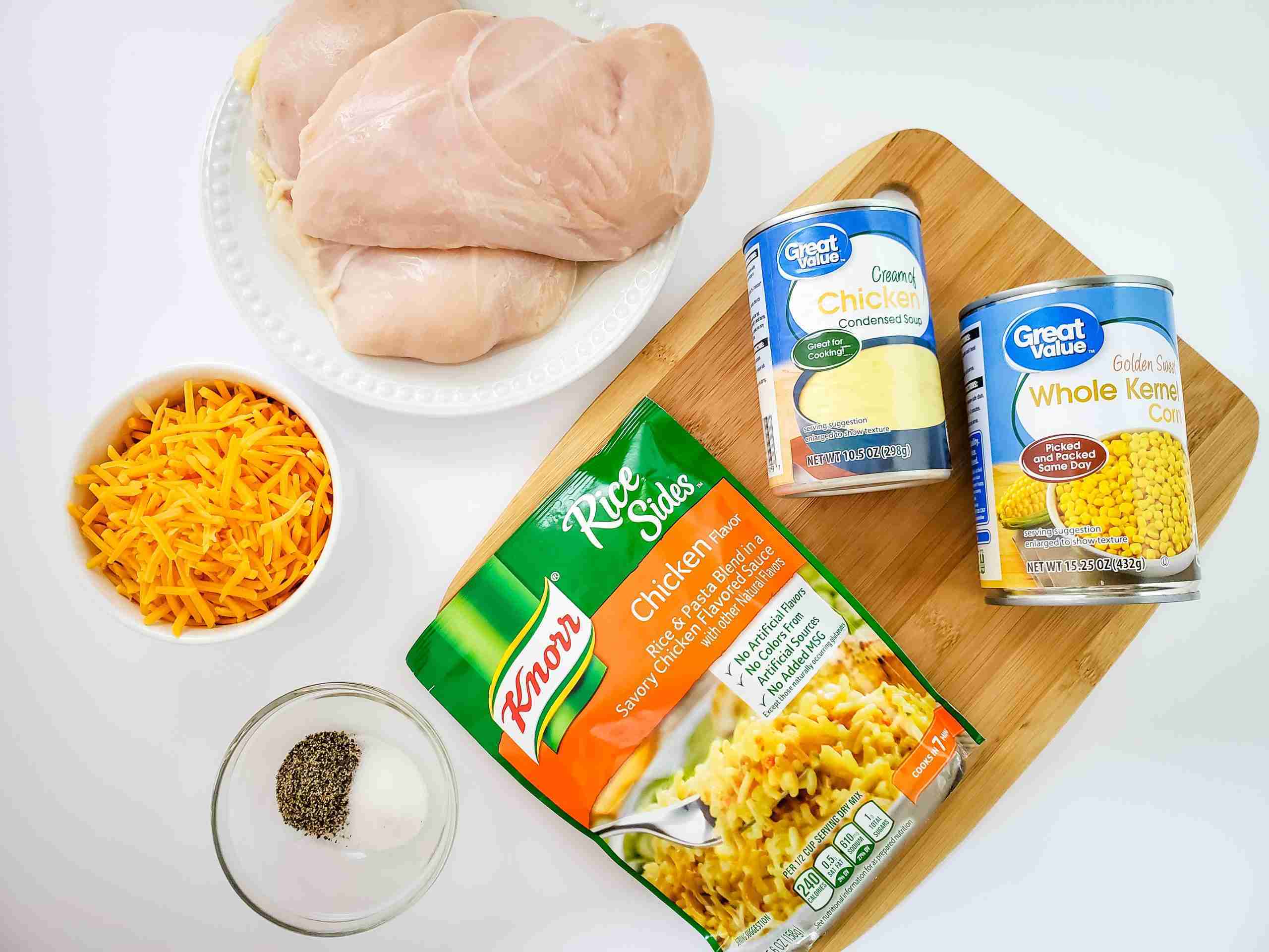 knorr chicken flavored rice, chicken breast, shredded cheddar cheese, great value cream of chicken soup, great value whole kernel corn, wooden cutting board