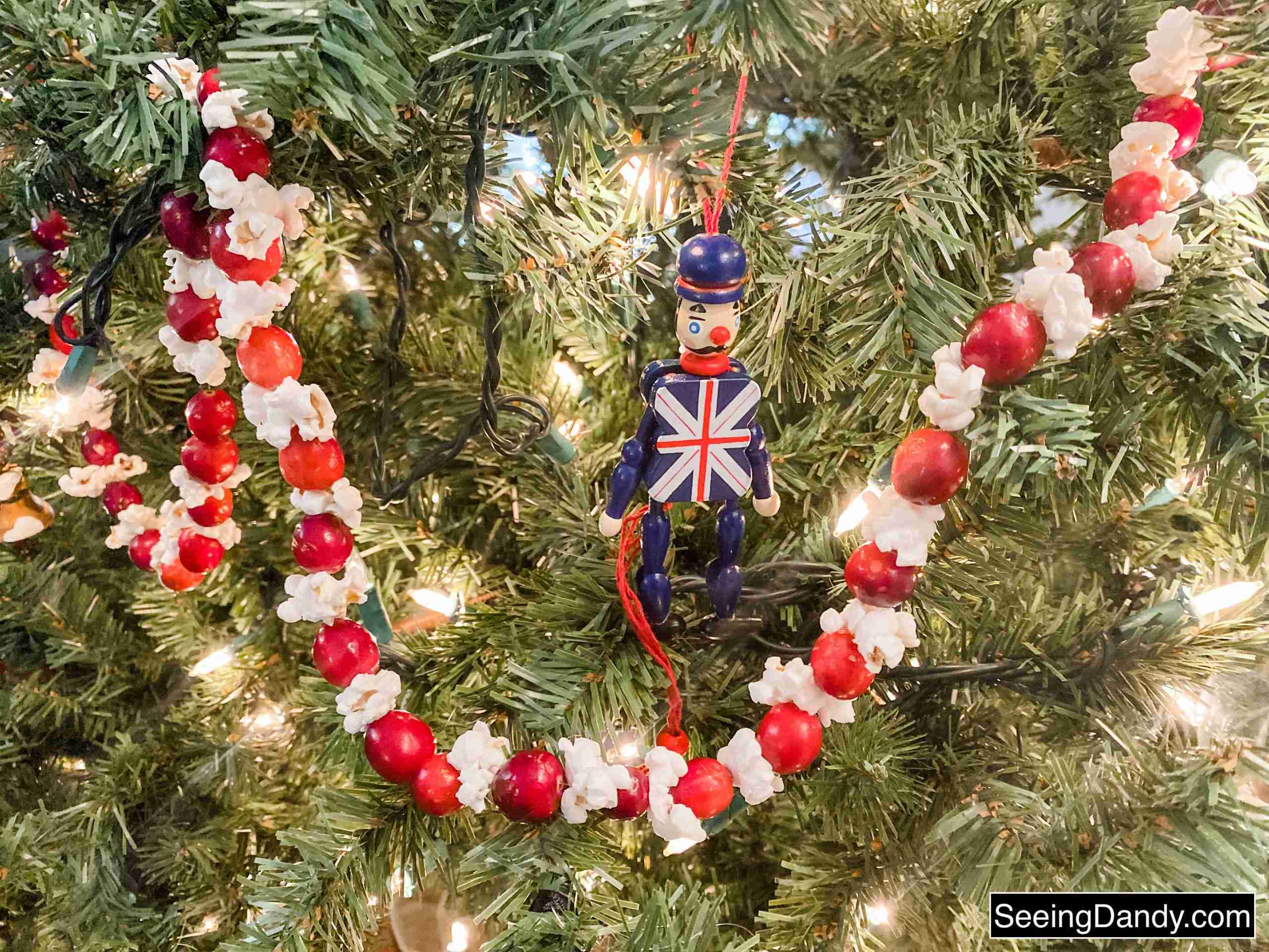cranberry popcorn garland on christmas tree with union jack ornament