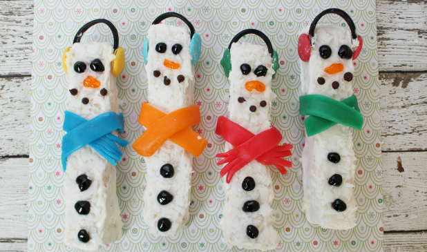White chocolate snowmen rice krispies treats on a festive background.