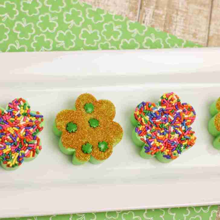 Shamrock shake fudge recipe on farmhouse table with St. Patrick's Day scrapbook paper.