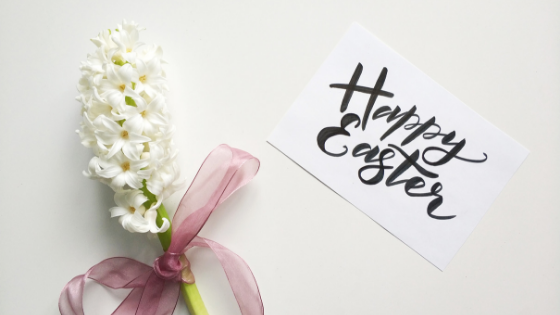 Happy Easter hand lettering with white flowers.