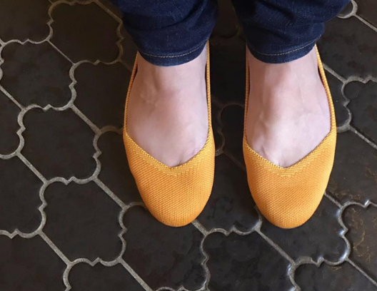 Yellow Rothy's ballet flat shoes.