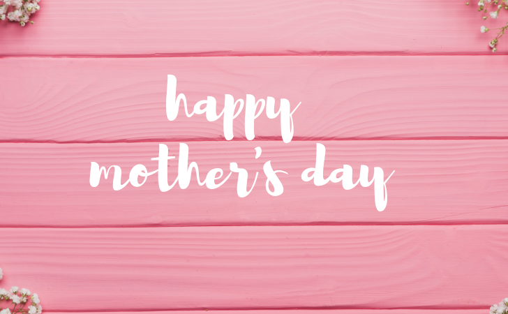 Happy Mothers Day with baby's breath and pink wooden background.