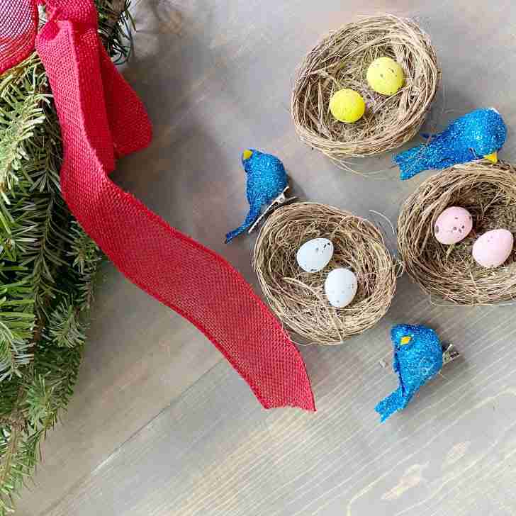 Blue bird nest Christmas tree ornament with pine swag red ribbon