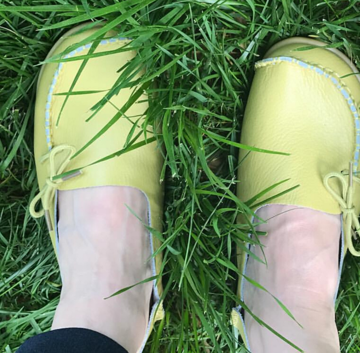 Apple green yellow moccasins in grass.
