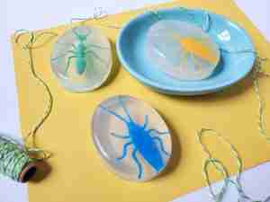 kids bug soap, yellow paper, plastic bugs, green white stripe string