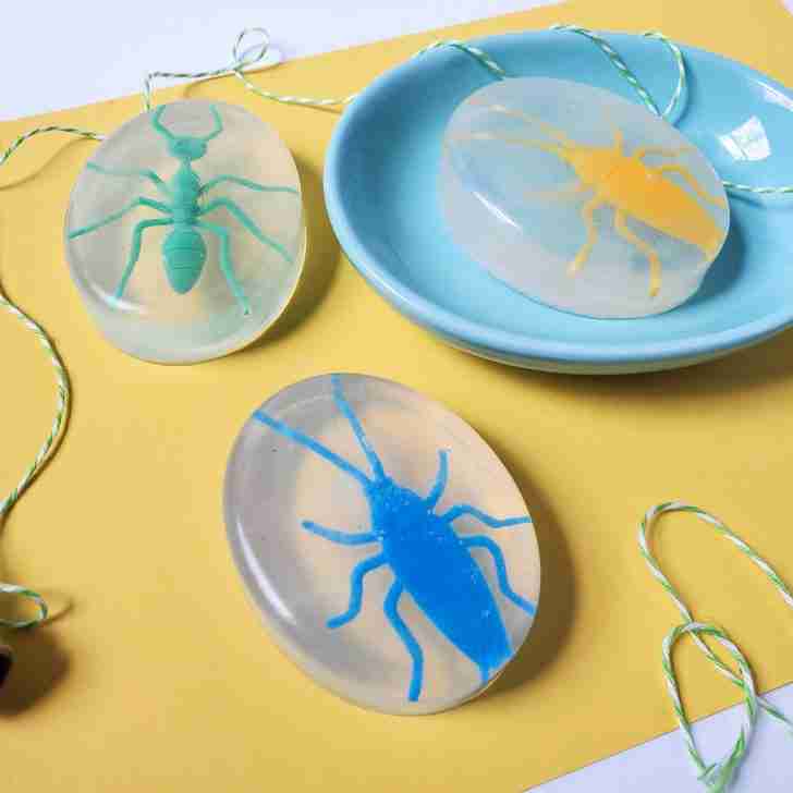 kids bug soap, yellow paper, plastic bugs, green white stripe string