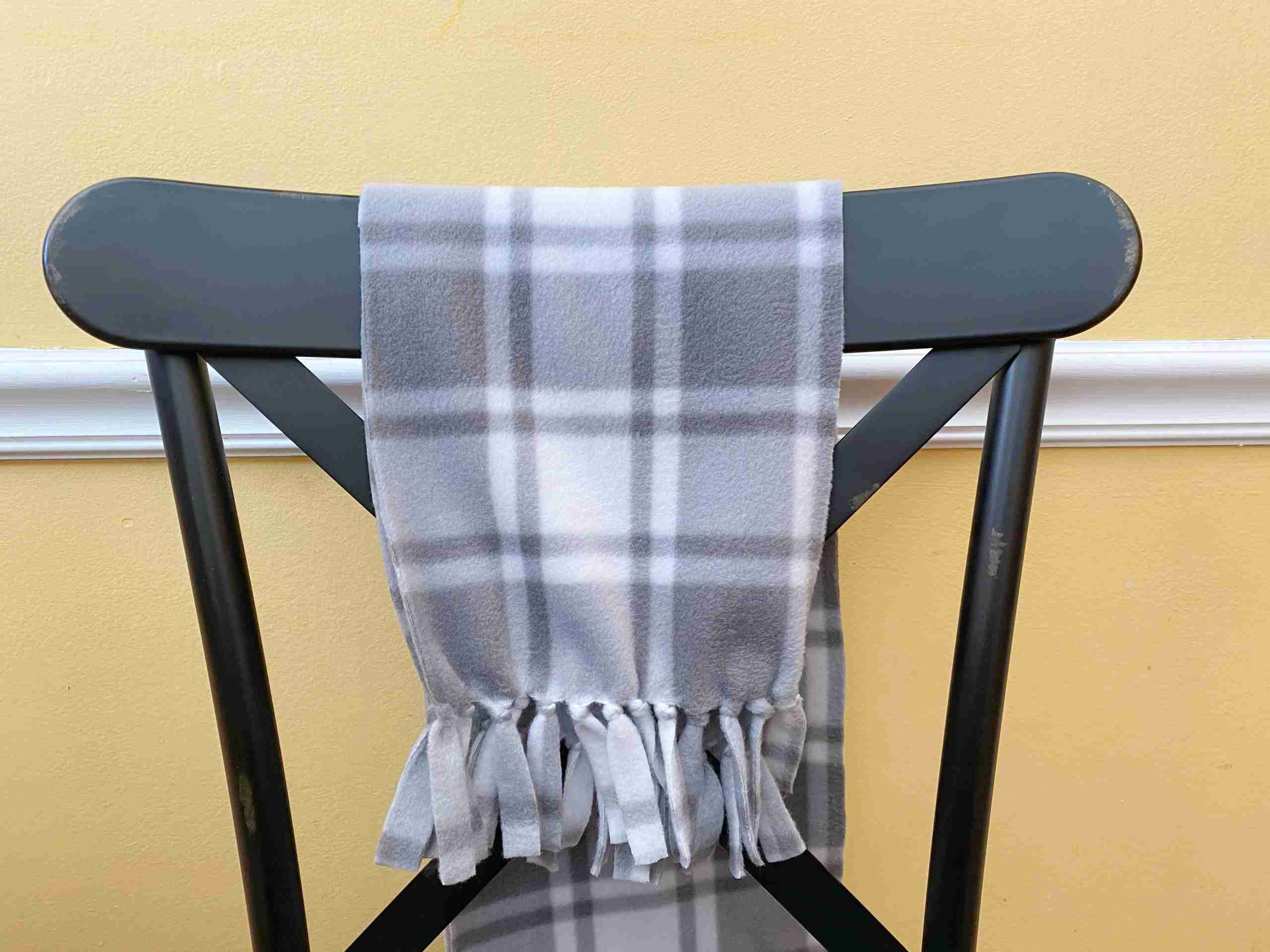 tied fleece scarf, gray plaid fleece scarf, black farmhouse style kitchen chair, metal dining chair, yellow kitchen wall, white kitchen chair rail, diy no sew fleece scarf