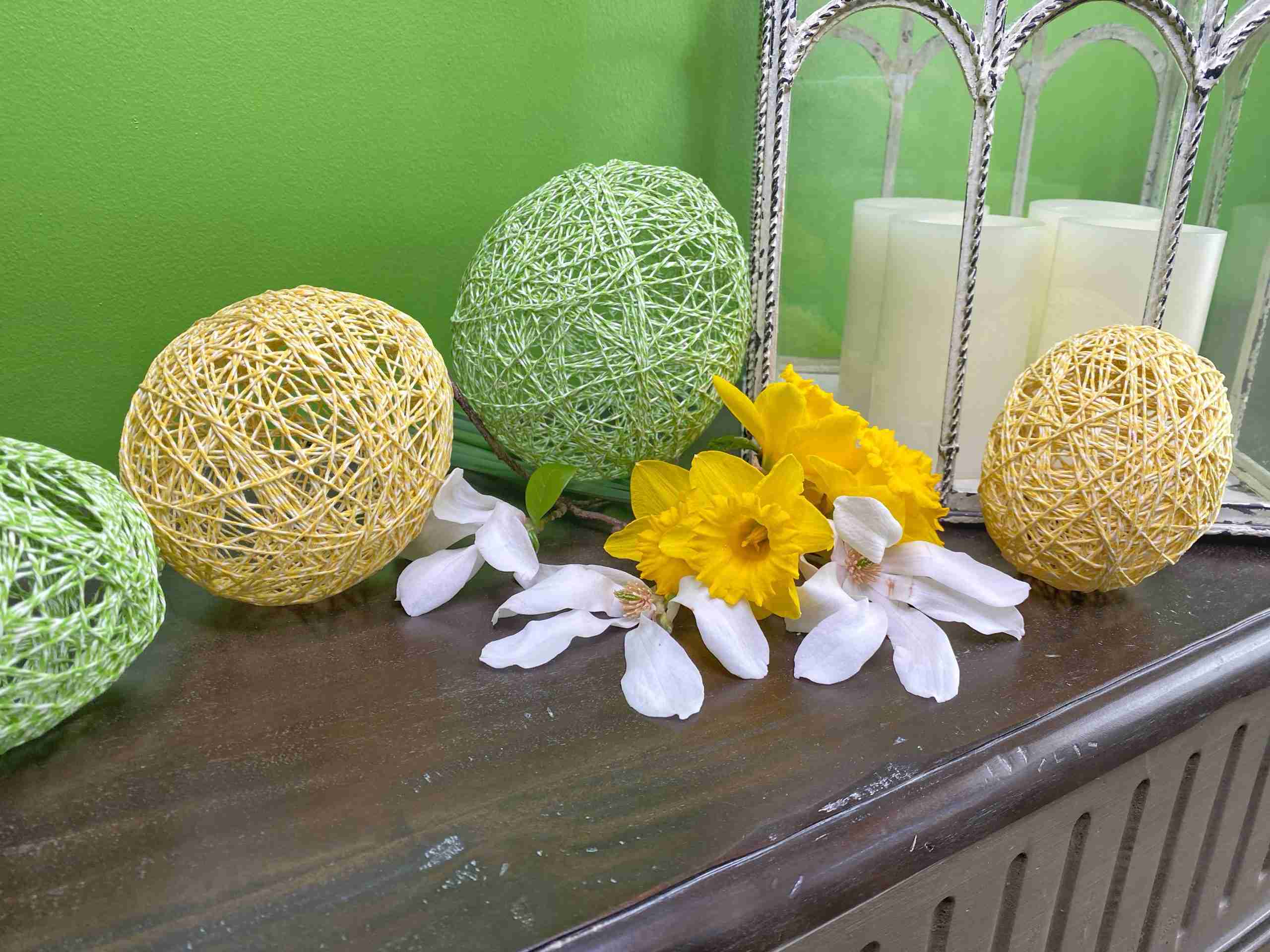 yellow string egg, green string egg, bakers twine easter eggs, string balloon egg, springtime, spring decor, easter decorations, farmhouse style, floral tree branch, spring flowers, yellow daffodils